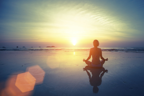 Meditating girl on sea background - Φωτογραφία, εικόνα