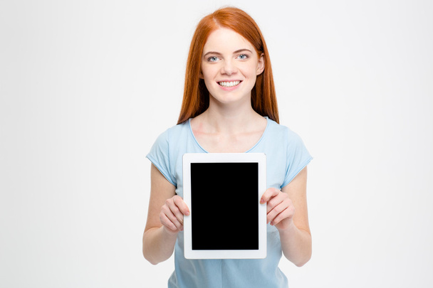 Redhead woman showing blank tablet computer screen - Fotoğraf, Görsel