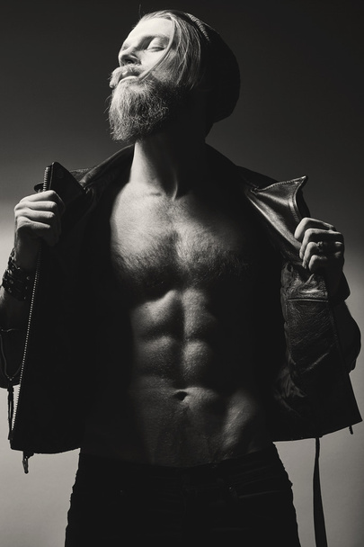 Brutal bearded man with bare-chested  posing over grey wall. - Foto, Imagem
