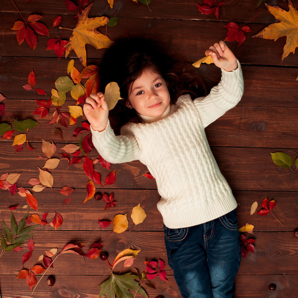 little cute girl with fallen leaves - Photo, Image