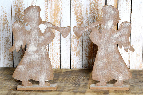Due figure di un angelo con una tromba fatta di legno. Angelo di Natale
 - Foto, immagini