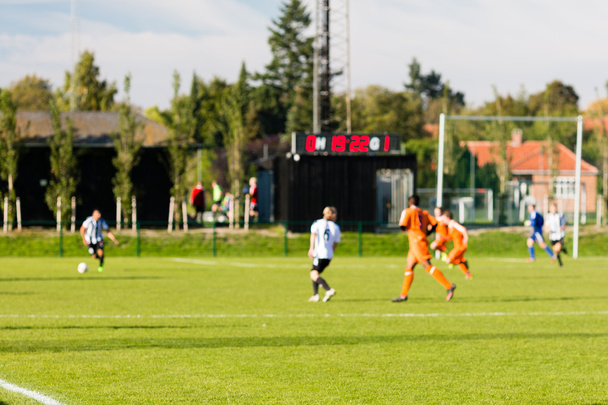 Blurred soccer players playing amateur soccer match - Fotó, kép