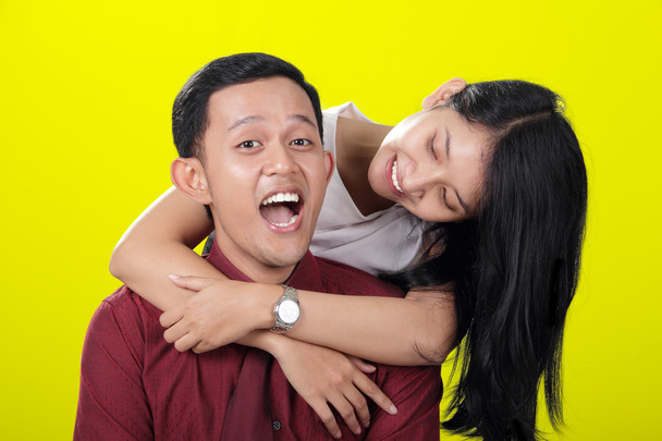 Happy cheerful couple on yellow background - Photo, Image