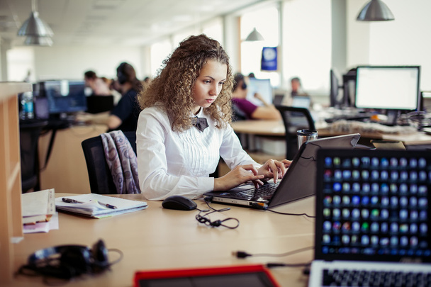 Young pretty business woman with notebook in the office - Photo, image