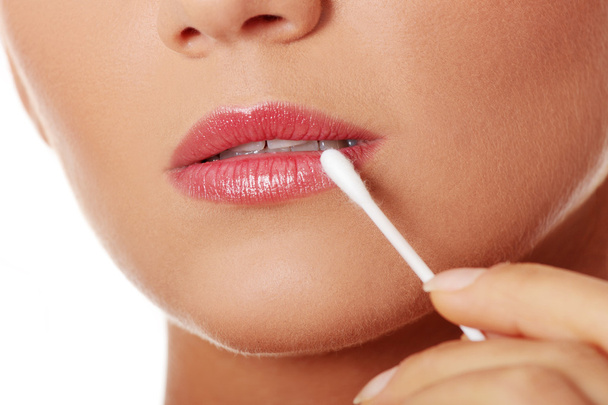 Touching lips with cotton stick - Фото, изображение
