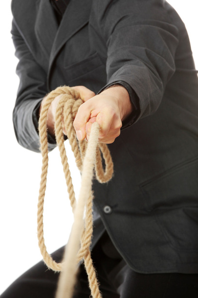 Businessman pulling on a rope. - Valokuva, kuva