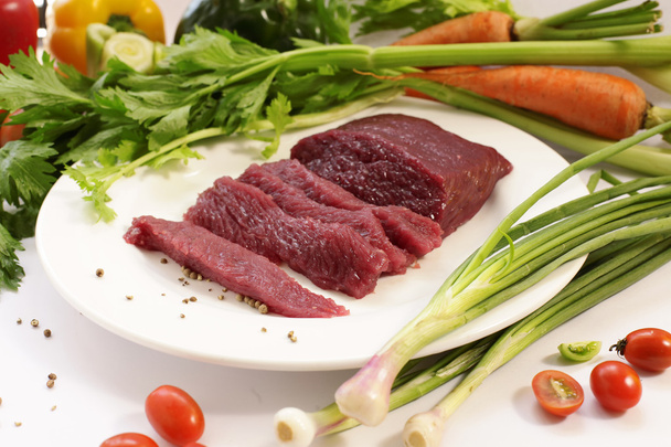 slice raw ostrich meat with vegetable - Photo, Image