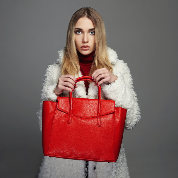 Winter beautiful Woman with red Handbag. Beauty Fashion Model Girl in fur. - 写真・画像