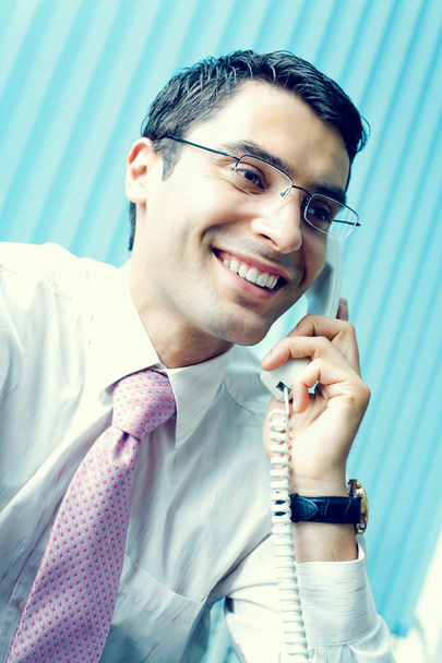 Businessman with phone at office - Foto, imagen