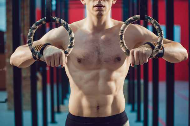 Athlete prepare for exercise on rings - Photo, Image
