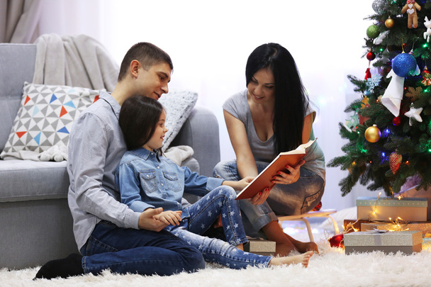 Happy family read book in the decorated Christmas room - Foto, immagini