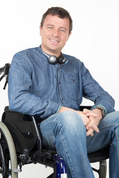 Portrait of disabled man on wheelchair over white background - Foto, Imagem
