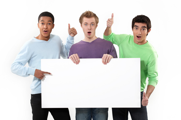Expressive men holding a white sign for message - Φωτογραφία, εικόνα