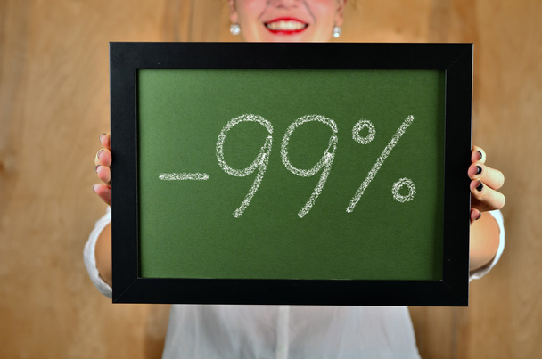 a girl holds a sign saying sale - 99 percent - Photo, Image