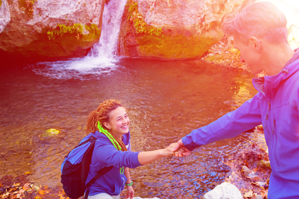 Two Hikers young Man and Smiling Woman holding hands Sunny - Фото, зображення