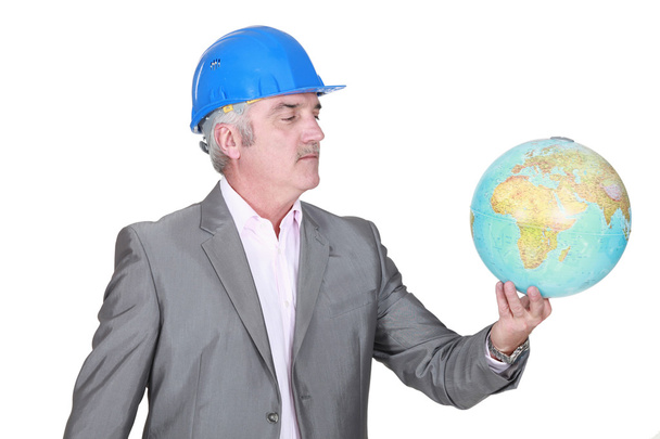 Engineer holding a globe - Zdjęcie, obraz