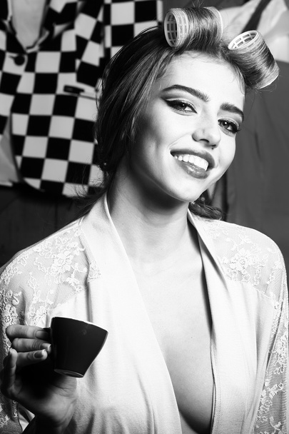 Woman with hair-curlers and coffee - Foto, Imagen