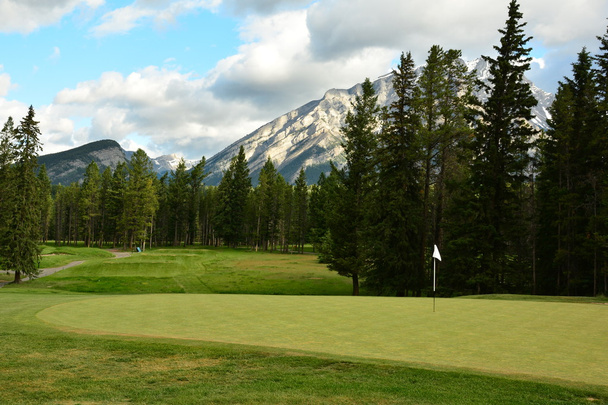 Golfing in the Rockie Mountains of Banff - Photo, Image