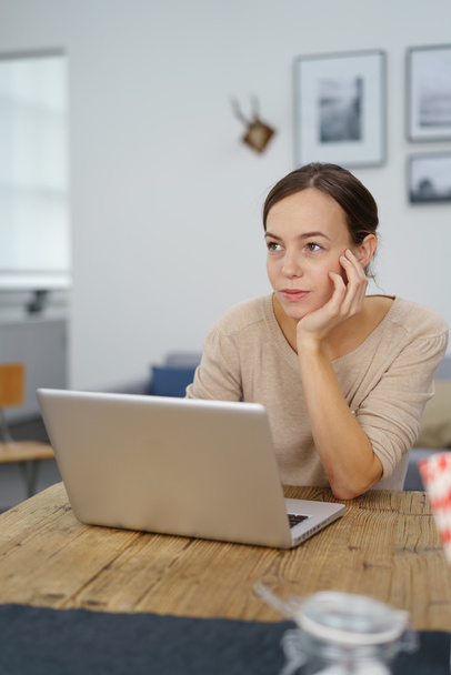 Thoughtful Woman with Laptop Looking Away - Фото, зображення