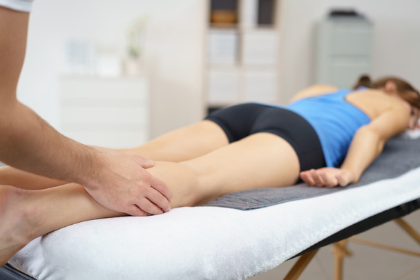 Physical Therapist Massaging the Legs of Patient - Foto, Imagen