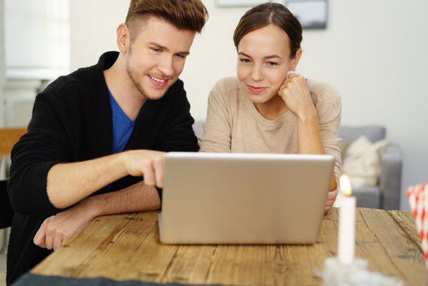 young couple at home focused on notebook - Φωτογραφία, εικόνα