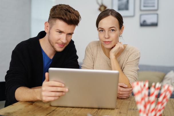young man and woman sitting at desk at home - Photo, Image