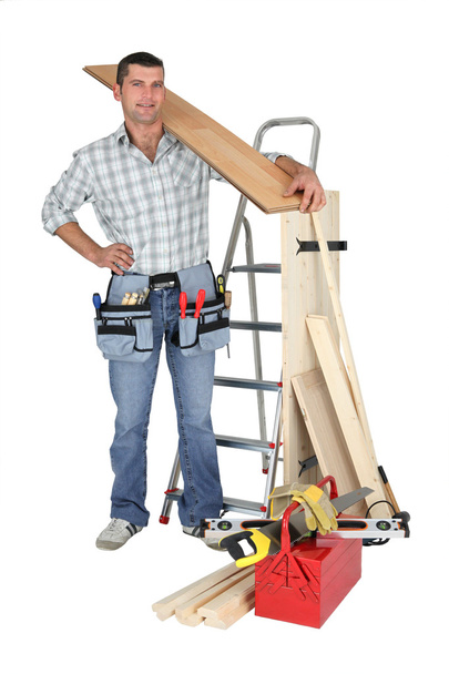 Craftsman holding a wooden floor board - Photo, Image