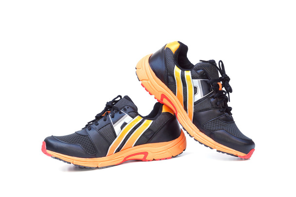 chaussures de course aux couleurs noir et orange
 - Photo, image
