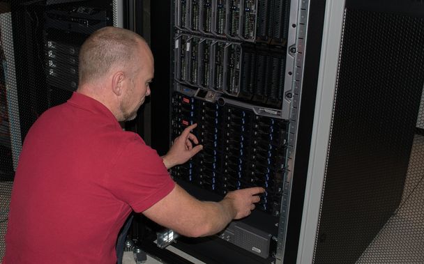 IT consultant performs work in a data center - Photo, Image