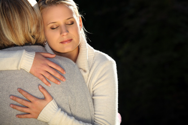 A mother and her teenage daughter hugging. - Fotografie, Obrázek