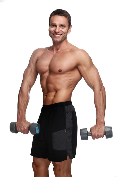 muscular guy with dumbells. - Фото, зображення