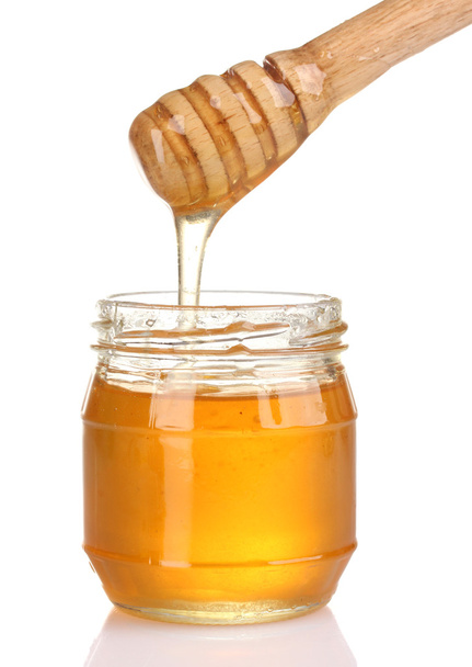 Jar of honey and wooden drizzler isolated on white - Φωτογραφία, εικόνα