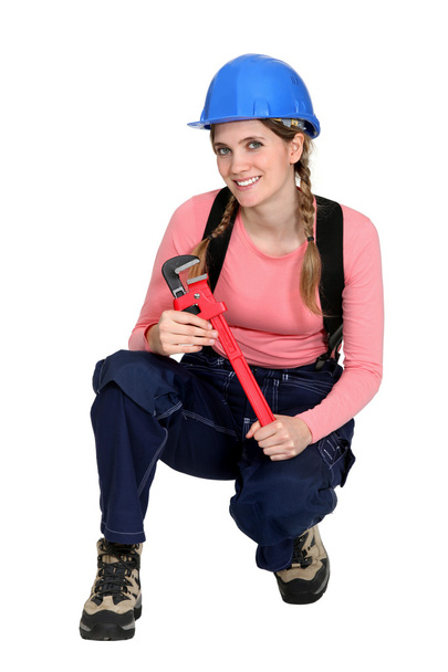 A kneeled female construction worker. - Valokuva, kuva