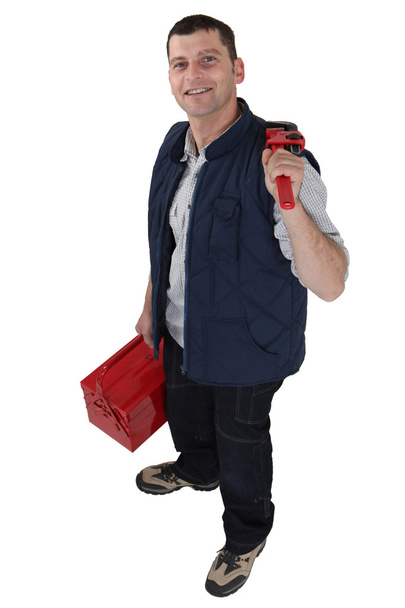 Man carrying a toolbox and a pipe wrench - Photo, image