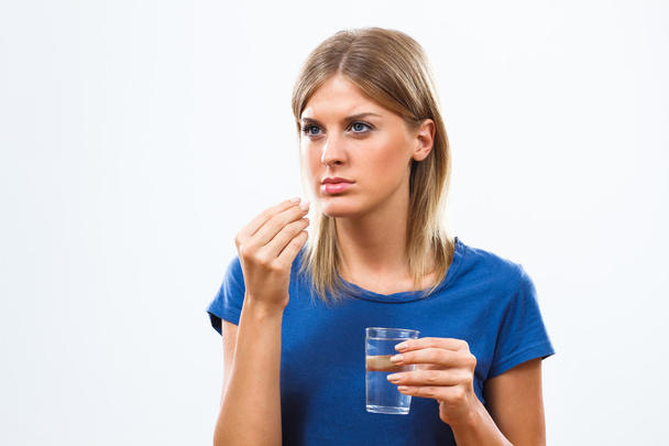 young woman taking pill - Photo, image