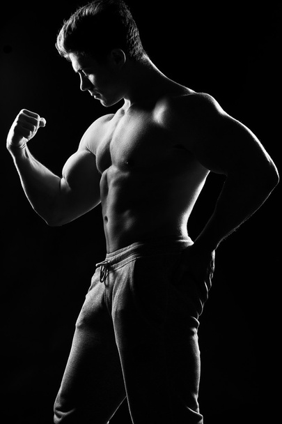 Sexy muscular fitness man. Black and white image.  - Fotó, kép