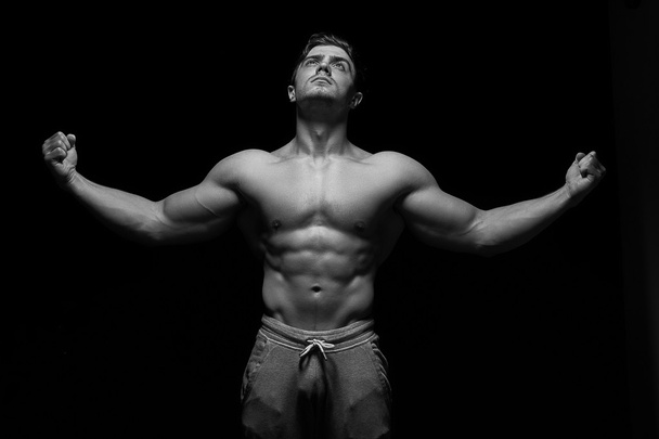Sexy muscular fitness man. Black and white image.  - Zdjęcie, obraz