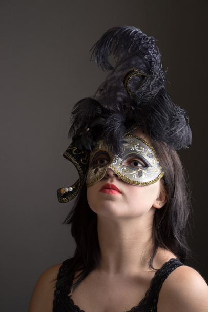 closeup portrait of young girl in black venetian mask. - Photo, Image
