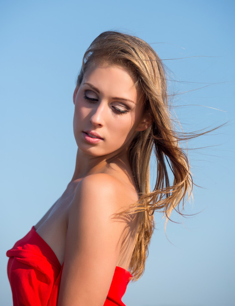 Beautiful young woman in red fabric - Fotoğraf, Görsel