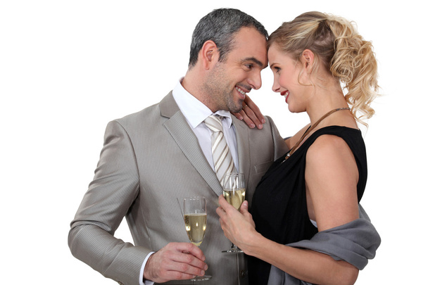 Couple drinking champagne in studio - Foto, afbeelding