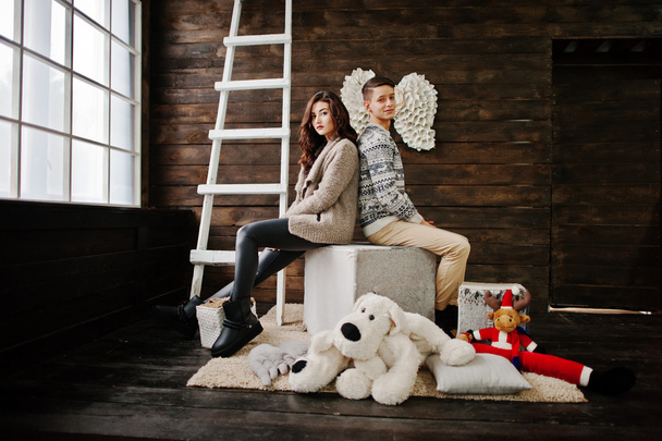 Young fashion winter  couple at wooden background  - Foto, Imagem