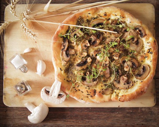 homemade Italian pizza with mushrooms and pesto - 写真・画像