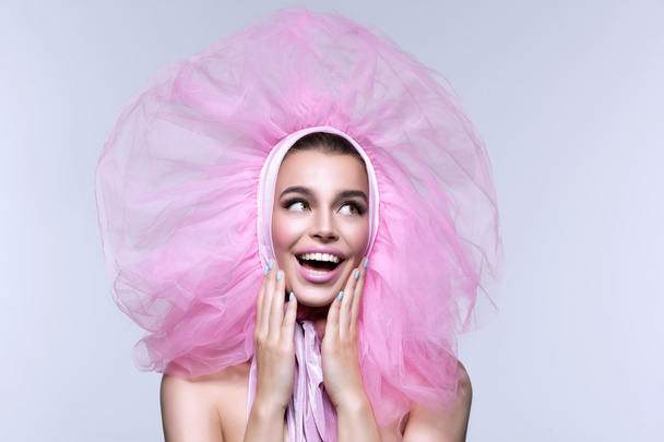 Beautiful girl in fluffy pink headwear - Photo, Image