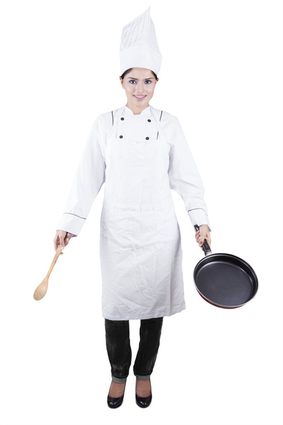 Indian chef holds spoon and frying pan - Zdjęcie, obraz