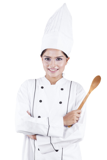 Indian female chef holding wooden spoon - 写真・画像