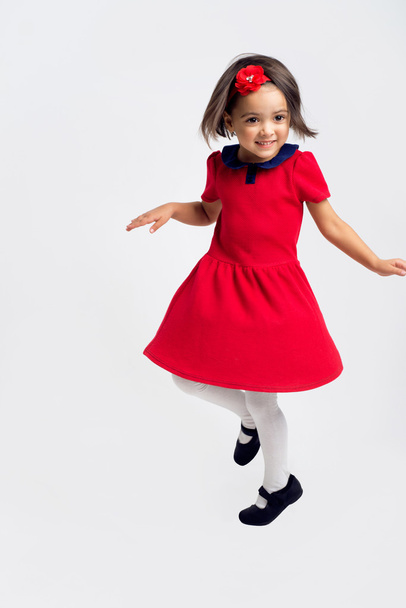 Beautiful little Girl smiling in red dress - Fotó, kép