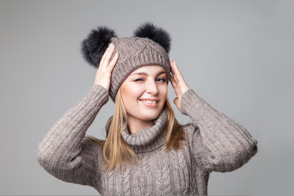 Beautiful blond girl wears winter pullover and hat - Zdjęcie, obraz