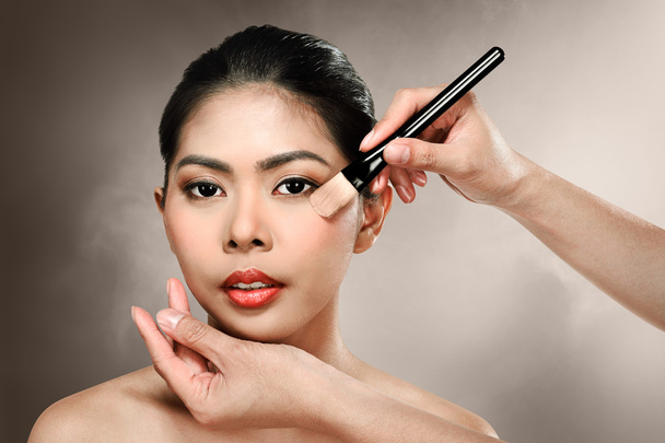 Beautiful asian woman doing makeup - Photo, image