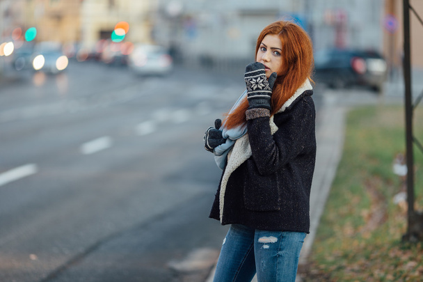 Red-haired girl standing on the street and laugh - Valokuva, kuva