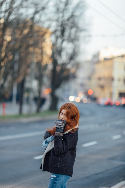 Red-haired girl standing on the street and laugh - Fotoğraf, Görsel